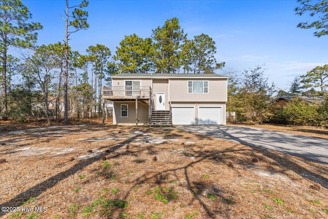 split foyer home featuring a garage and a deck