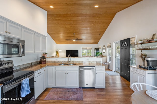 kitchen with wood ceiling, stainless steel appliances, and kitchen peninsula