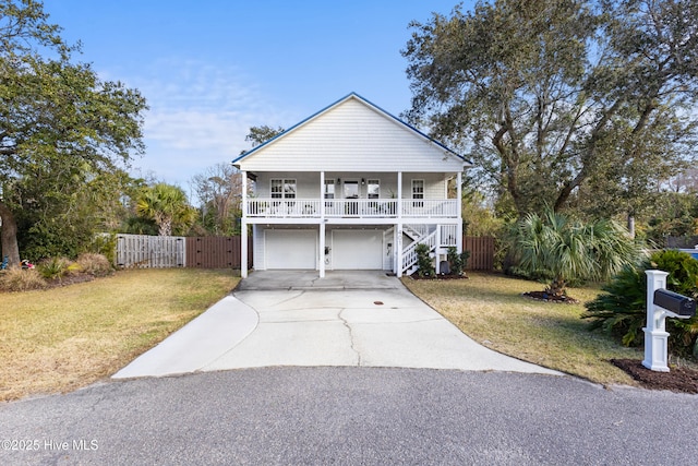 view of front of home featuring a front yard, a garage, and covered porch