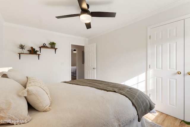 bedroom with ornamental molding, ceiling fan, and wood-type flooring