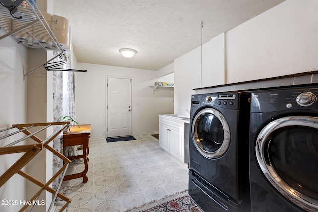 washroom featuring sink, separate washer and dryer, and cabinets