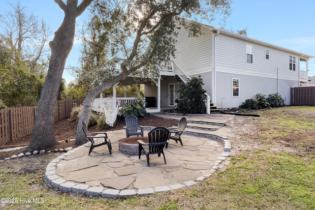 back of house featuring a fire pit and a patio