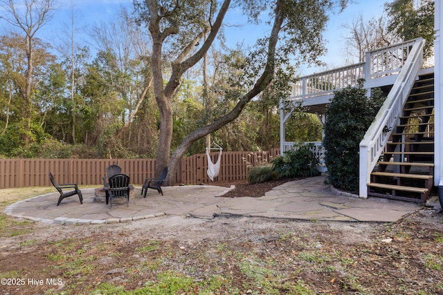 view of yard featuring a fire pit and a patio