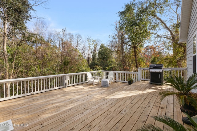 wooden terrace with a grill