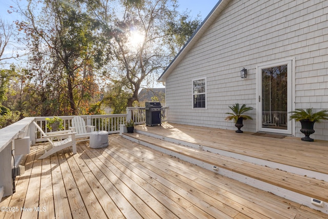 wooden terrace with a grill