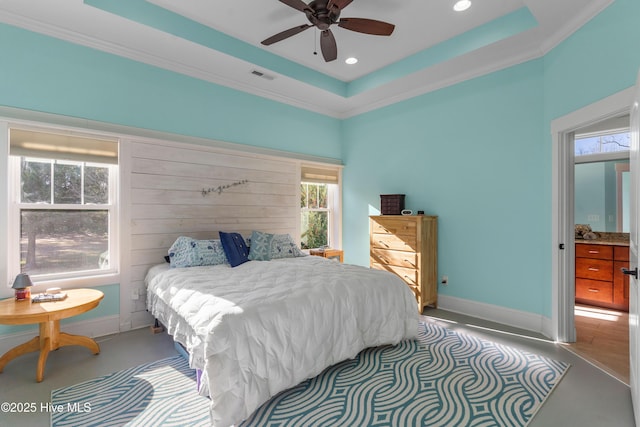 bedroom with ceiling fan, ornamental molding, and a tray ceiling