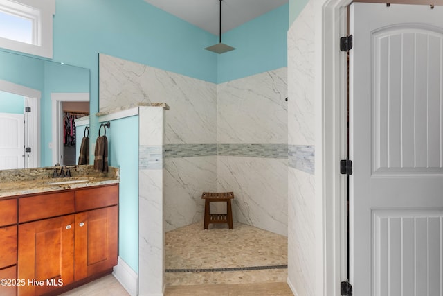 bathroom featuring a shower and vanity