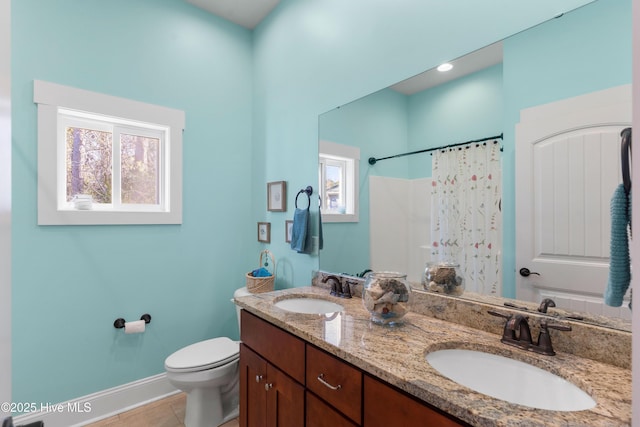 bathroom with toilet, vanity, tile patterned floors, and curtained shower