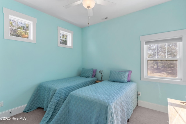 bedroom with ceiling fan and light carpet