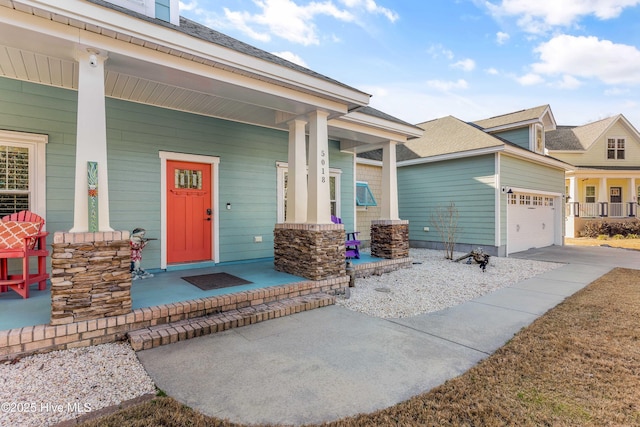 view of front of house featuring a porch and a garage