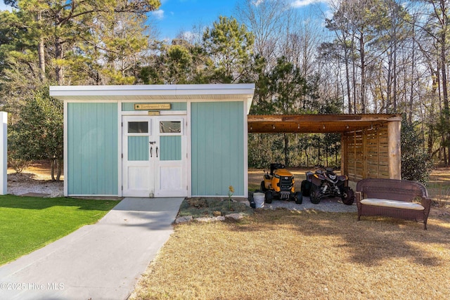 view of outbuilding featuring a lawn