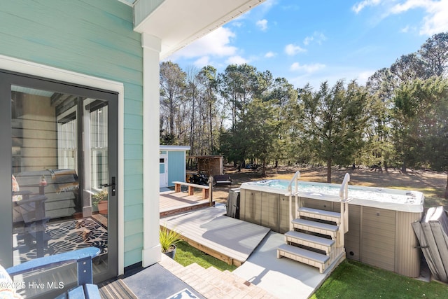 wooden deck with a hot tub