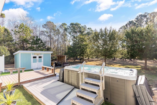 wooden deck with an outbuilding and a hot tub