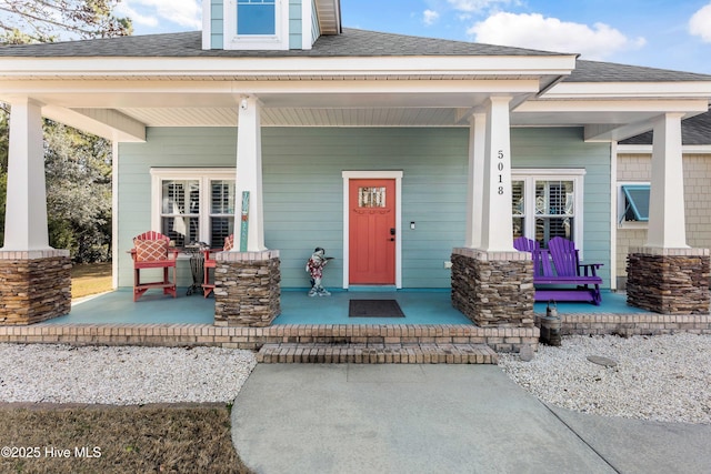 view of exterior entry with covered porch