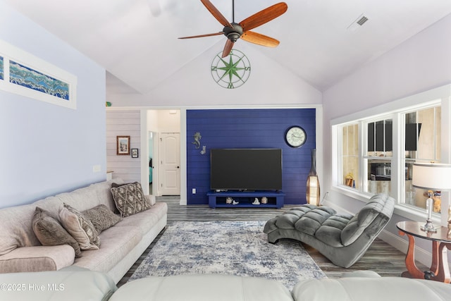 living room featuring ceiling fan, dark hardwood / wood-style floors, and lofted ceiling