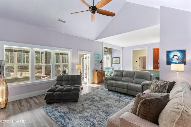 living room featuring ceiling fan, light hardwood / wood-style flooring, and high vaulted ceiling