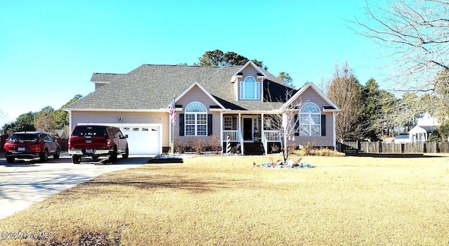 front of property featuring covered porch, a front yard, and a garage