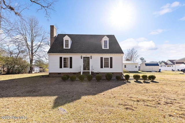 new england style home featuring a front yard