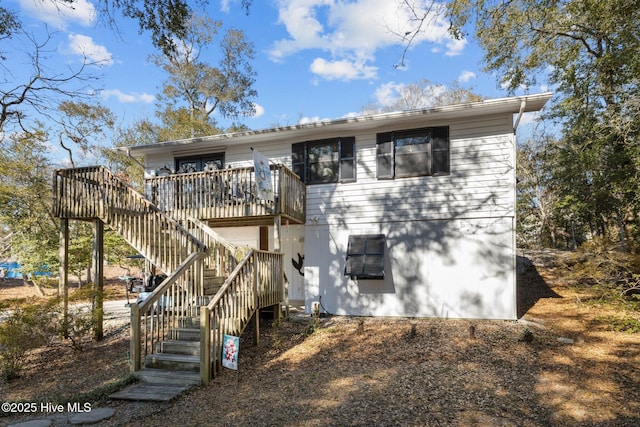 rear view of house with a wooden deck