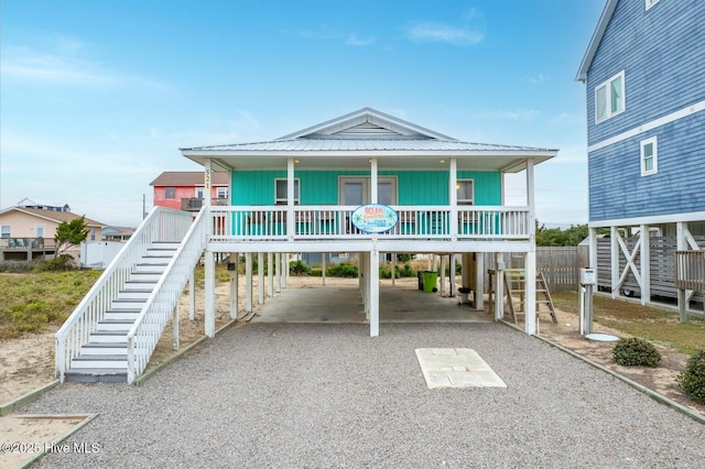 coastal home with covered porch and a carport