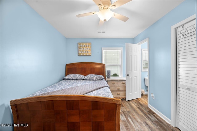 bedroom with wood-type flooring, a closet, and ceiling fan