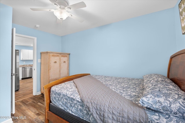 bedroom with ceiling fan and dark hardwood / wood-style flooring