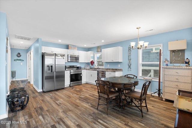 dining room with a chandelier, dark hardwood / wood-style floors, and sink