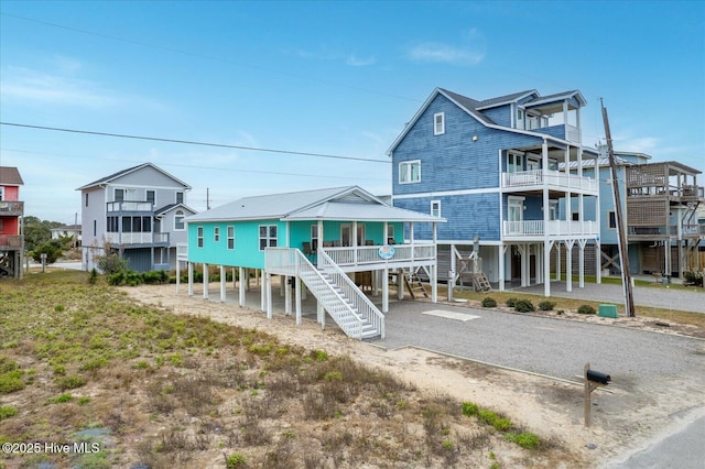 back of house featuring a carport