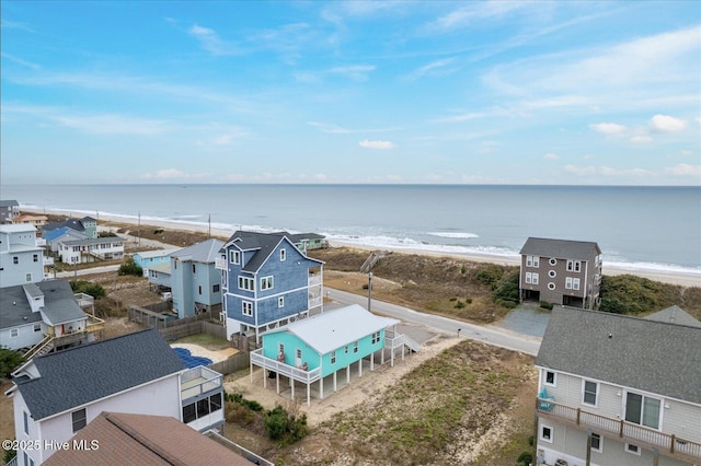 bird's eye view with a water view and a beach view