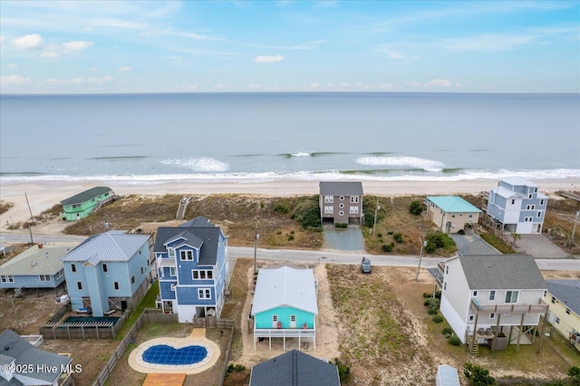 drone / aerial view with a water view and a beach view