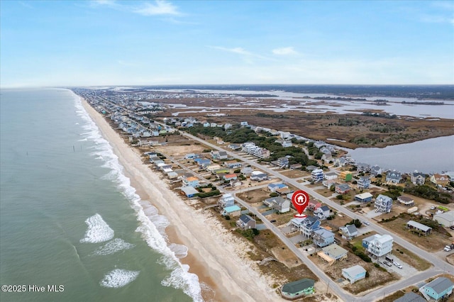 birds eye view of property with a view of the beach and a water view