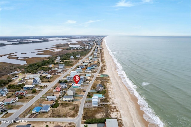 aerial view with a water view and a beach view