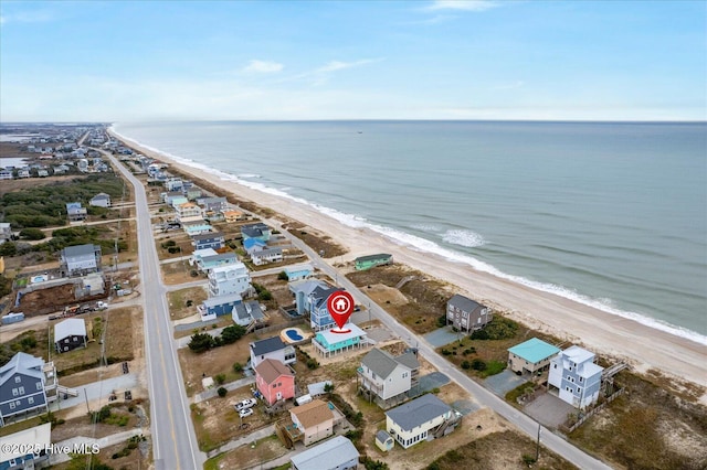 drone / aerial view featuring a water view and a beach view