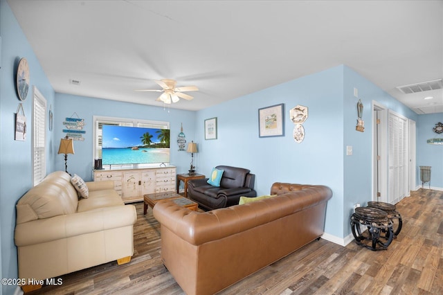 living room with ceiling fan and wood-type flooring