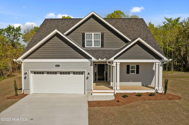craftsman inspired home featuring driveway, a shingled roof, a front lawn, and covered porch