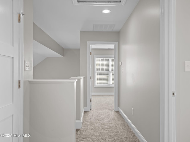 hallway with baseboards, visible vents, an upstairs landing, recessed lighting, and carpet floors