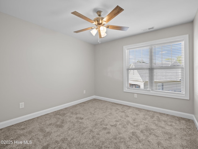 unfurnished room with ceiling fan, baseboards, visible vents, and carpet