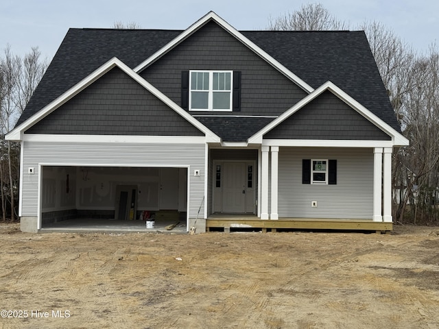 view of front of property with a garage and covered porch