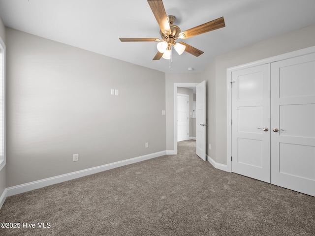 unfurnished bedroom with ceiling fan, baseboards, carpet flooring, and a closet