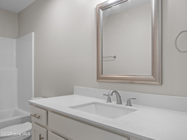 full bathroom with bathing tub / shower combination, vanity, and toilet
