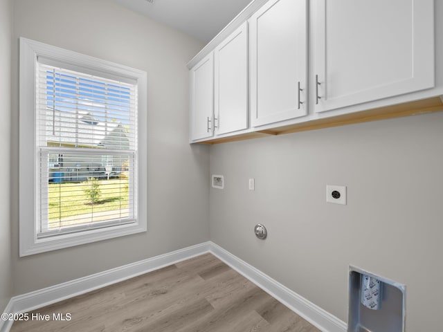laundry room with hookup for a washing machine, a healthy amount of sunlight, light wood-style floors, and cabinet space