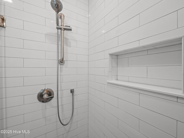 bathroom with a tile shower