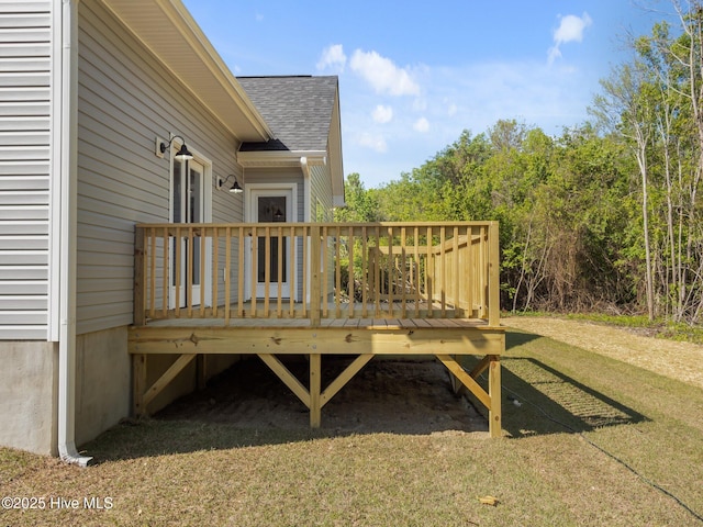 wooden terrace featuring a yard