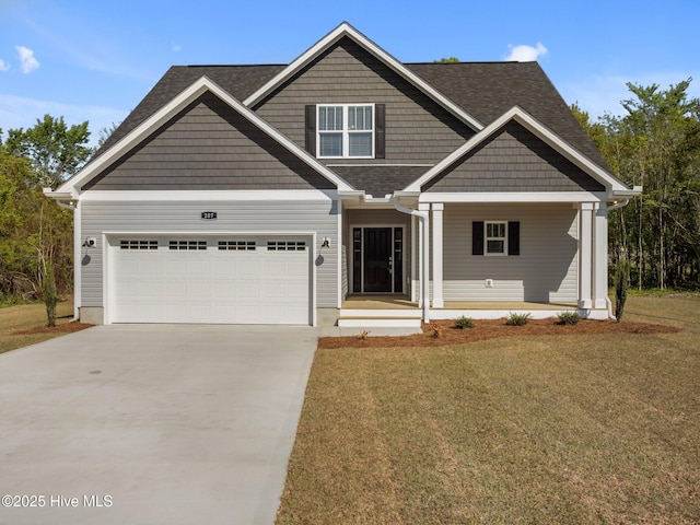 craftsman house with concrete driveway, an attached garage, a porch, a front yard, and roof with shingles