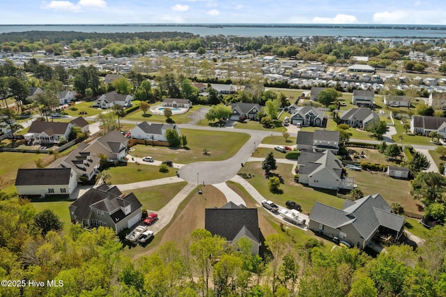 drone / aerial view featuring a water view and a residential view