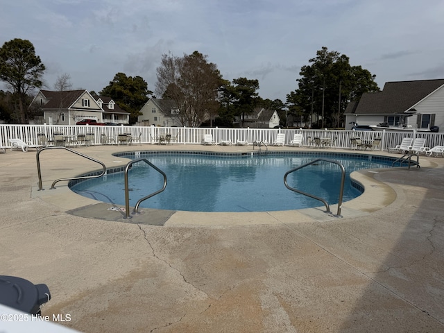 pool featuring a patio area and fence