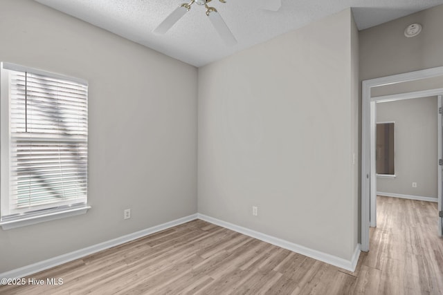 2214 Splitbrook Ct, Wilmington, NC 28411 - empty room featuring light wood-style flooring, ceiling fan, baseboards, a smoke detector, and a textured ceiling