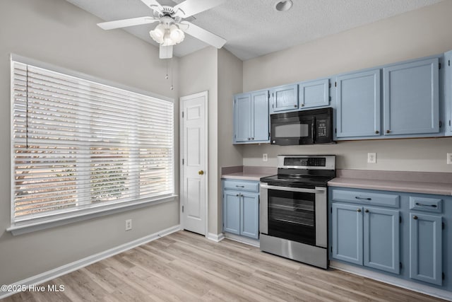 kitchen featuring ceiling fan, stainless steel electric range, blue cabinets, and a textured ceiling