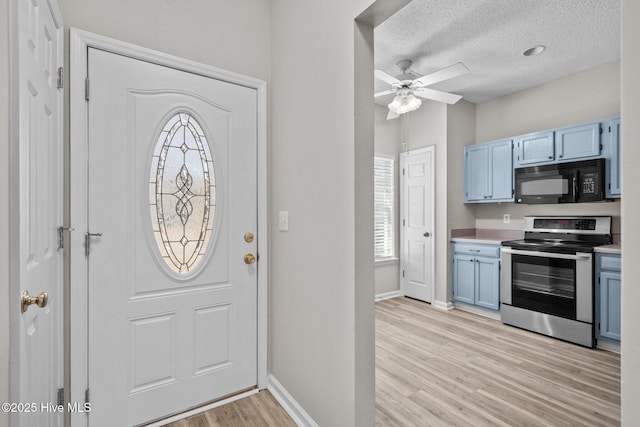 2214 Splitbrook Ct, Wilmington, NC 28411 - foyer featuring light wood-type flooring, baseboards, a ceiling fan, and a textured ceiling