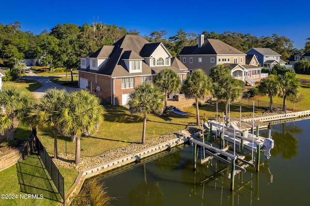 exterior space featuring a water view and a lawn